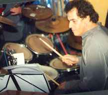 drummer Dominique Pizzinat drumming on stage 